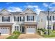 Charming townhome featuring stone accents, a one-car garage, and lush landscaping at 2513 Asher View Ct, Raleigh, NC 27606