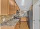 Functional kitchen with wooden cabinets, stainless steel appliances, and laminate countertops at 2513 Asher View Ct, Raleigh, NC 27606