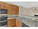 Well-lit kitchen featuring stainless steel double sink, appliances, and light wood cabinets at 2513 Asher View Ct, Raleigh, NC 27606
