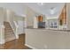 View of kitchen with light wood cabinets, black appliances, and breakfast bar at 2513 Asher View Ct, Raleigh, NC 27606