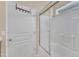 Close-up of a bright bathroom shower with glass doors and white tiled walls at 2513 Asher View Ct, Raleigh, NC 27606