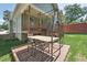 Outdoor deck with an outdoor dining set, ideal for entertaining and enjoying the beautiful, fenced backyard at 2620 Holloway St, Durham, NC 27703