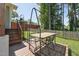 Outdoor deck with an outdoor dining set, ideal for entertaining and enjoying the beautiful, fenced backyard at 2620 Holloway St, Durham, NC 27703