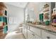 Bathroom featuring dual sinks, granite countertop, open shelving, and a walk-in shower at 2620 Holloway St, Durham, NC 27703