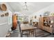 View of the open-concept dining room featuring a modern light fixture and hardwood floors at 2620 Holloway St, Durham, NC 27703