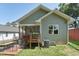 Exterior view of the backyard featuring a deck, AC unit, and grass at 2620 Holloway St, Durham, NC 27703