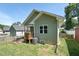 Exterior view of the backyard featuring a deck, AC unit, and grass at 2620 Holloway St, Durham, NC 27703