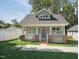 Charming single-Gathering home featuring a welcoming front porch and well-maintained lawn at 2620 Holloway St, Durham, NC 27703