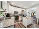 Well-lit kitchen with white cabinets, stainless steel appliances, and a central island at 2620 Holloway St, Durham, NC 27703