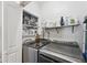 Efficient laundry room with modern washer and dryer, ample storage shelves, and organized cleaning supplies at 2620 Holloway St, Durham, NC 27703