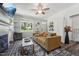 Cozy living room with large windows, a decorative fireplace, and comfortable seating at 2620 Holloway St, Durham, NC 27703