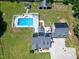 An aerial view showing a well-maintained property featuring solar panels, a pool, and outdoor amenities at 2709 Les Paul Ln, Apex, NC 27539