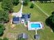 A captivating aerial view of a house with solar panels, a pool, and spacious outdoor areas at 2709 Les Paul Ln, Apex, NC 27539