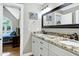Bathroom with vanity, mirror, and an entrance into the primary bedroom at 2709 Les Paul Ln, Apex, NC 27539