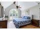 Spacious primary bedroom features a large window, hardwood floors and a ceiling fan at 2709 Les Paul Ln, Apex, NC 27539