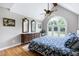 A well-lit primary bedroom with large windows and hardwood floors at 2709 Les Paul Ln, Apex, NC 27539