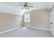 This bedroom features neutral walls, carpeted floors, a ceiling fan, and a window for natural light at 2709 Les Paul Ln, Apex, NC 27539