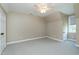 The bedroom has a ceiling fan, neutral colored walls, gray carpet, a closet, and a window at 2709 Les Paul Ln, Apex, NC 27539