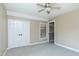 This bedroom has gray carpet, neutral walls, double closets, and a peek at an attic door at 2709 Les Paul Ln, Apex, NC 27539