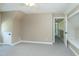 Bedroom with gray carpet, neutral walls, ceiling fan, and attic door to the left of the room at 2709 Les Paul Ln, Apex, NC 27539
