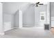 Bright bonus room features gray carpet, light walls, interesting ceiling, and a side window at 2709 Les Paul Ln, Apex, NC 27539