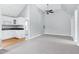 Bonus room with light walls, hardwood and gray carpet flooring, unique ceiling, and kitchen area at 2709 Les Paul Ln, Apex, NC 27539