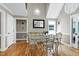Bright dining room with hardwood floors, large window, and stylish decor at 2709 Les Paul Ln, Apex, NC 27539