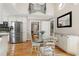Open dining room with a glass table, stainless steel fridge, and stylish decor at 2709 Les Paul Ln, Apex, NC 27539
