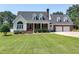 Charming two-story brick home with well-manicured lawn and dormer windows at 2709 Les Paul Ln, Apex, NC 27539