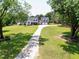 Beautiful home exterior with a long driveway, well-manicured lawn, and lush trees providing a serene and private setting at 2709 Les Paul Ln, Apex, NC 27539