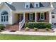 Welcoming front porch with comfortable seating and manicured landscaping at 2709 Les Paul Ln, Apex, NC 27539