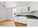 Charming kitchen features white cabinets, updated appliances, and hardwood floors near bright window at 2709 Les Paul Ln, Apex, NC 27539