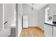 Bright kitchen features white cabinets, hardwood floors and view to stairs at 2709 Les Paul Ln, Apex, NC 27539
