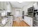 Charming kitchen with stainless steel sink, appliances, and mosaic backsplash at 2709 Les Paul Ln, Apex, NC 27539