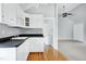 Updated kitchen with modern white cabinets, hardwood floors, and access to multiple rooms at 2709 Les Paul Ln, Apex, NC 27539