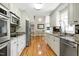 Bright kitchen with stainless steel appliances, granite countertops, and hardwood floors at 2709 Les Paul Ln, Apex, NC 27539