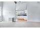 Open living space features light gray walls, gray carpets and a view of the kitchen at 2709 Les Paul Ln, Apex, NC 27539