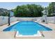 Fenced-in inground pool with slide, basketball hoop, and ample space for entertaining at 2709 Les Paul Ln, Apex, NC 27539