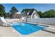 Inground pool with slide and diving board in fenced backyard at 2709 Les Paul Ln, Apex, NC 27539