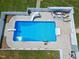Aerial view of sparkling inground pool with slide, diving board, and patio seating at 2709 Les Paul Ln, Apex, NC 27539