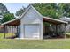 Exterior of a shed featuring covered storage, a single garage door, and a well-maintained lawn at 2709 Les Paul Ln, Apex, NC 27539