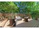 Relaxing back deck with patio furniture, surrounded by lush trees, offering a private outdoor space at 2901 Ceremonial Ct, Raleigh, NC 27615