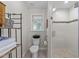Modern bathroom featuring a glass-enclosed shower, neutral tiles, and a stylish toilet at 2901 Ceremonial Ct, Raleigh, NC 27615