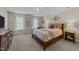 Serene bedroom features neutral tones, a decorative accent wall, and bright natural light at 2901 Ceremonial Ct, Raleigh, NC 27615
