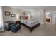 Comfortable bedroom with warm lighting, a plush chair, and access to an ensuite bathroom at 2901 Ceremonial Ct, Raleigh, NC 27615
