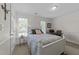 Bright bedroom with large windows and white furniture create a relaxing, inviting space at 2901 Ceremonial Ct, Raleigh, NC 27615