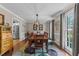 Dining room with hardwood floors, elegant lighting, and neutral color palette at 2901 Ceremonial Ct, Raleigh, NC 27615
