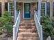 Inviting front porch with brick steps and a bright blue front door at 2901 Ceremonial Ct, Raleigh, NC 27615