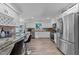 Bright kitchen boasts stainless steel appliances, white cabinetry, and views out a window at 2901 Ceremonial Ct, Raleigh, NC 27615