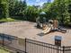 Community playground with swings, slides, and play structures for children at 2901 Ceremonial Ct, Raleigh, NC 27615